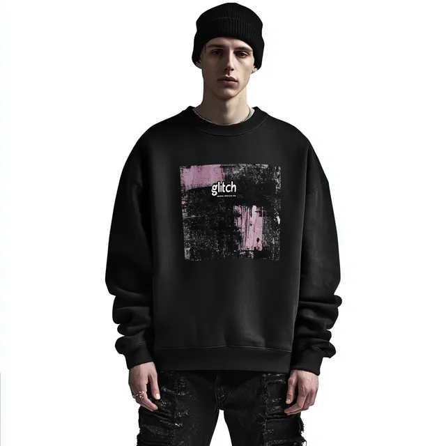 Young man in oversized black sweatshirt and baggy jeans in urban setting
