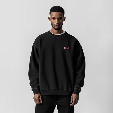 imagine print for textile sweatshirt using as a main theme "glitch" on a black washed sweatshirt, oversized fit and round neck collar, worn by a man in black baggy jeans, white background, streetwear style, high-resolution photography
