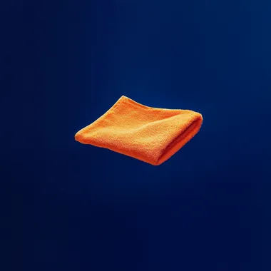 small orange washcloth floating against solid dark royal blue background