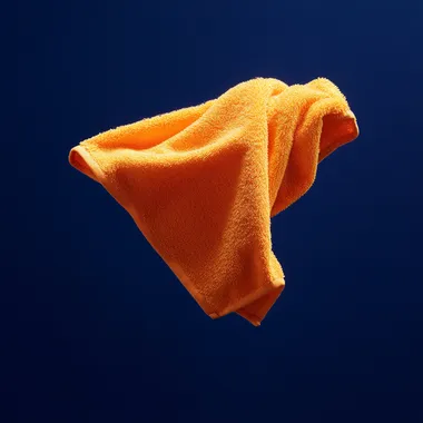 small orange washcloth floating against solid dark royal blue background