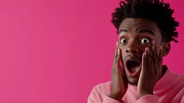 A surprised person with a shocked expression, standing to the right side of the image, with their hands on their face. The background is entirely pink, vibrant and eye-catching. The style is hyper-realistic, with a focus on the emotions displayed in the person's face, leaving ample space on the left side for adding text, hyper-realistic, photo realism, cinematography