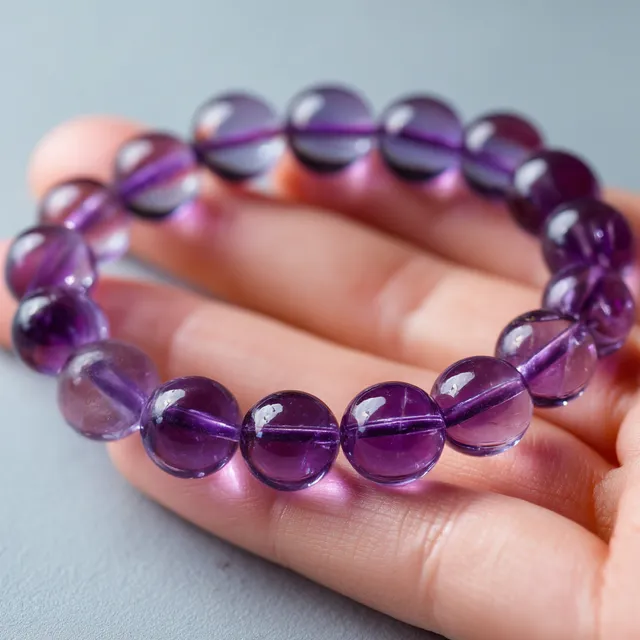Elegant 10mm Amethyst Beaded Bracelet on Woman's Hand