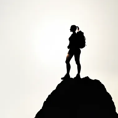 Silhouette of a fit woman standing on top of a peak, minimalist, hiking gear, light and shadows