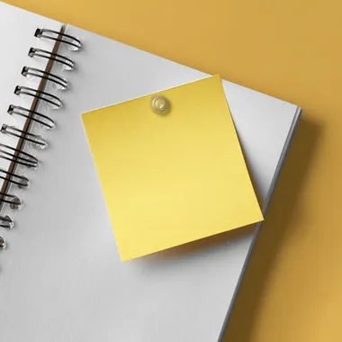 a piece of sticky note paper stuck to a page, top view