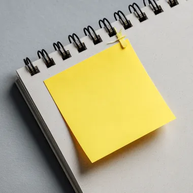 a piece of sticky note paper stuck to a page, top view